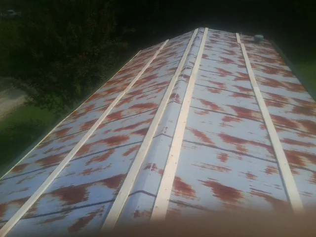 Rusted metal roof panels with new wood purlins before replacement — Storm Damage Roof Repair in Spindale by Roofing Brothers